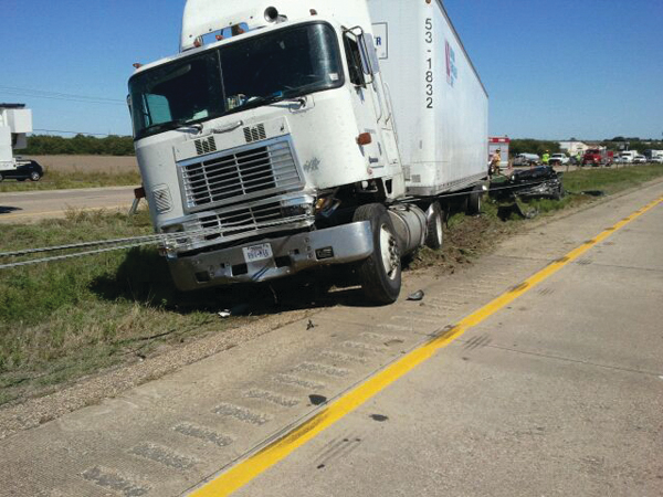 This truck is contacting the cable system, however the degree of contact still allows full access to the cab through either door. The degree of obstruction presented by the cables must focus on whether any doors are blocked and whether side windows, the windshield, or the roof area of the vehicle are directly contacted by the high-tension cables.