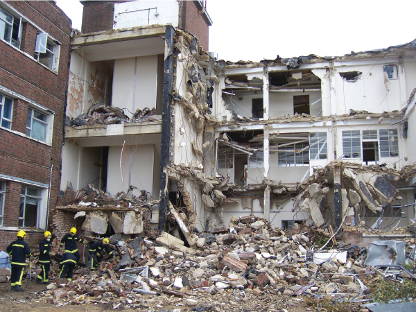 Exercise participants remove loose debris from a secondary collapse site.