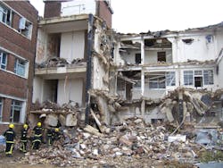 Exercise participants remove loose debris from a secondary collapse site. Exercise participants remove loose debris from a secondary collapse site.
