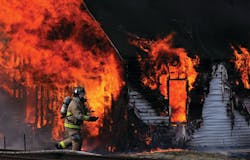 A Maysville firefighter prepares to battle a house fire on Feb. 23 that killed two small children. A Maysville firefighter prepares to battle a house fire on Feb. 23 that killed two small children.