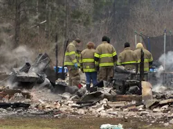 Members of the Beauregard Parish Fire Department look over the scene of an early morning fire that claimed the lives of a mother and her two children. Members of the Beauregard Parish Fire Department look over the scene of an early morning fire that claimed the lives of a mother and her two children.