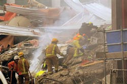 Rescue workers sift through the debris of a collapsed building after an earthquake rocked Christchurch, New Zealand.