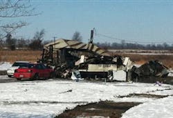 A mobile home is shown after a fire that killed two women and two men.