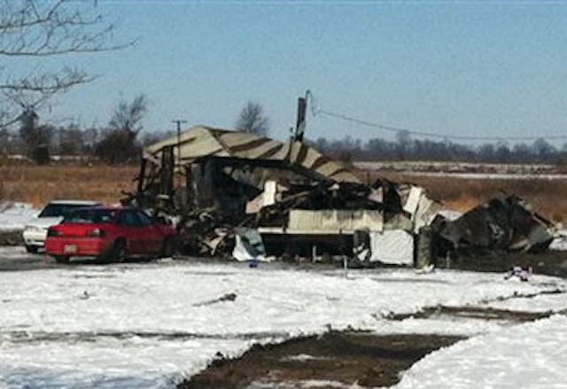 A mobile home is shown after a fire that killed two women and two men.