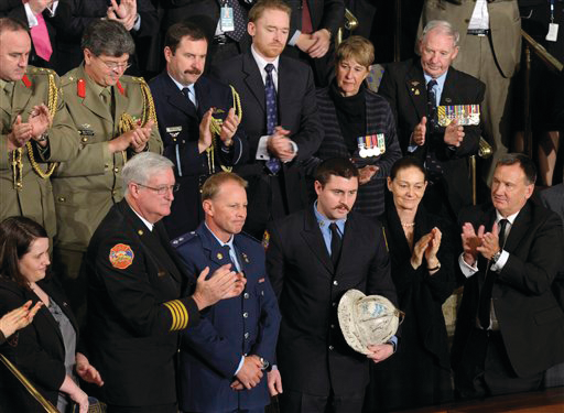 Australian Firefighter Rob Frey, third from front left, and FDNY Firefighter James Dowdell, holding helmet, are recognized in a speech by Australian Prime Minister Julia Gillard.