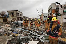 Members of a Fairfax County, Va. search and rescue team walk through a damaged area as they search for tsunami survivors in Ofunato, Japan on March 15. Members of a Fairfax County, Va. search and rescue team walk through a damaged area as they search for tsunami survivors in Ofunato, Japan on March 15.