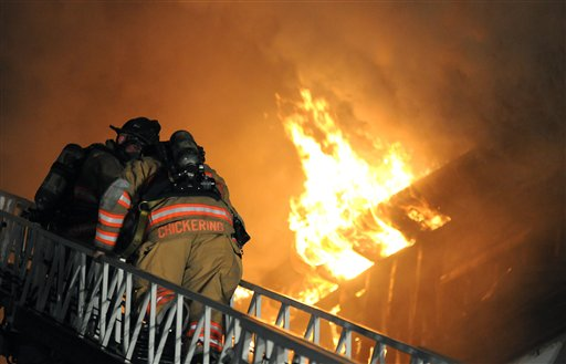Firefighters battle flames at a fire in Brattleboro, Vt.