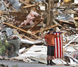 Justin Nichols, 16, stands with an American flag recovered from the Church of the Covenant debris in Bartow County, Ga., about two hours west of where the Wildcat fire station burned down. Justin Nichols, 16, stands with an American flag recovered from the Church of the Covenant debris in Bartow County, Ga., about two hours west of where the Wildcat fire station burned down.