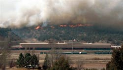 A wildfire rages behind the Ruidoso Downs Racetrack and Casino in Ruidoso Downs on April 3.