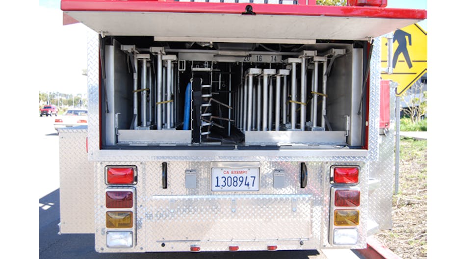 Aluminum ground ladders, including two 35-foot and two 28-foot extension ladders, are banked at the rear of the trailer. A backboard and pike poles are also nested here.