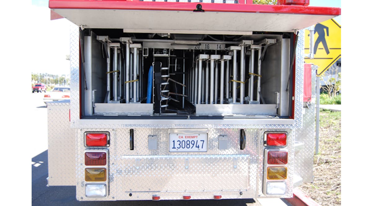 Aluminum ground ladders, including two 35-foot and two 28-foot extension ladders, are banked at the rear of the trailer. A backboard and pike poles are also nested here.