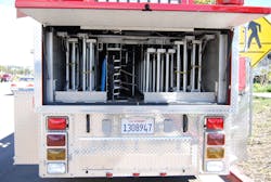 Aluminum ground ladders, including two 35-foot and two 28-foot extension ladders, are banked at the rear of the trailer. A backboard and pike poles are also nested here. Aluminum ground ladders, including two 35-foot and two 28-foot extension ladders, are banked at the rear of the trailer. A backboard and pike poles are also nested here.