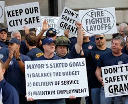 Cleveland firefighters rally outside City Hall in protest of the impending layoff of 51 firefighters due to budget cuts.