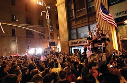 A large, jubilant crowd reacts to the news of Osama Bin Laden&apos;s death at the corner of Church and Vesey Streets, adjacent to ground zero.