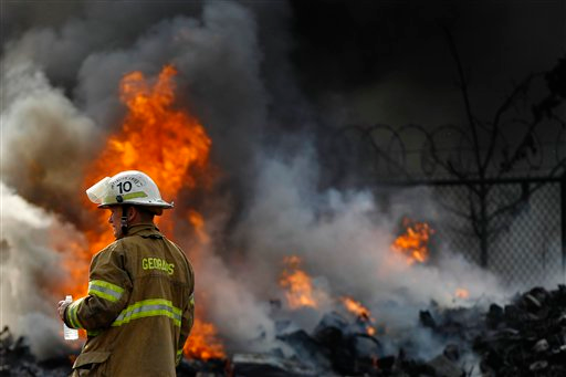A Philadelphia firefighter is seen amongst the smoke of a blaze at a recycling plant in the Bridesburg neighborhood.