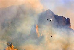 Firefighters work to contain a blaze behind the Boyce Thompson Arboretum on May 8. Firefighters work to contain a blaze behind the Boyce Thompson Arboretum on May 8.