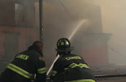 Firefighters battle a massive 12-alarm blaze Thursday at a former tire-distribution facility in Camden.