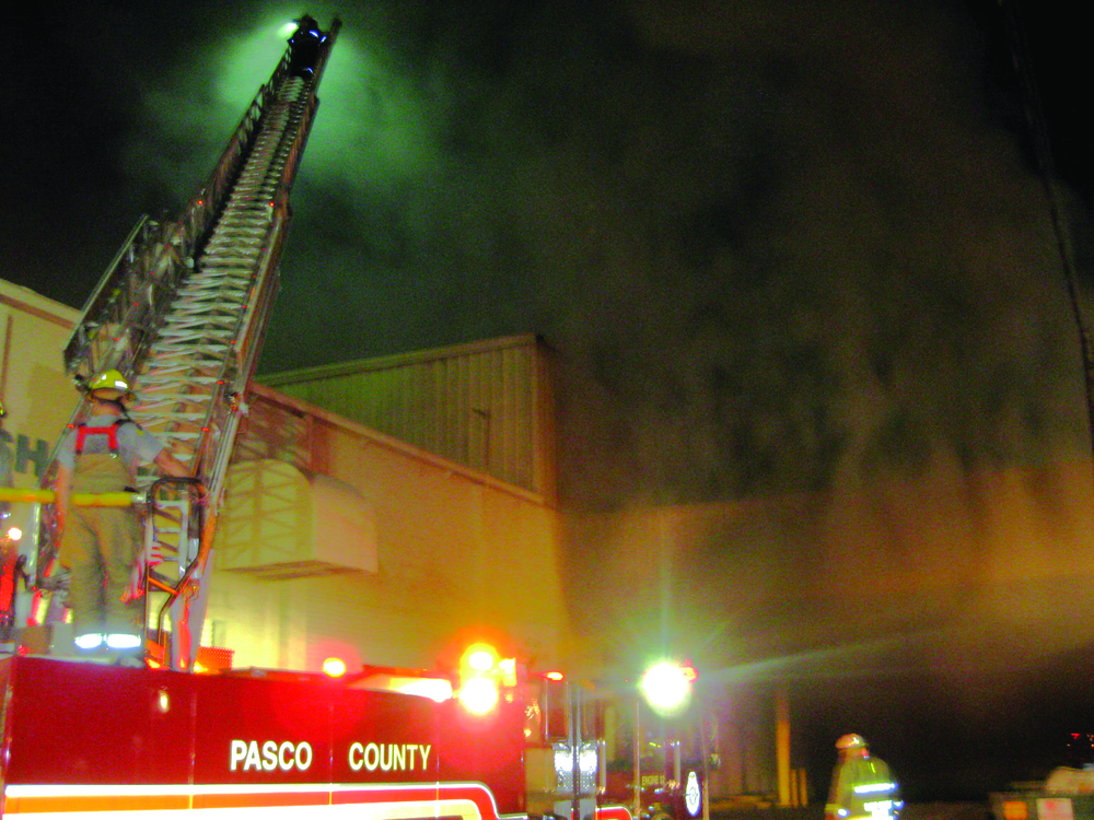 Early in the incident, Engine 32 operates its aerial at the intersection of sides A and B.