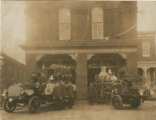 Members of Baltimore City, MD, Fire Department Engine Company 9 pose with their apparatus, a Christie tractor-driven steamer with their Mack hose wagon, in 1915.