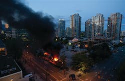 Smoke plumes rise from police cars set on fire following the Vancouver Canucks being defeated by the Boston Bruins in the NHL Stanley Cup Final in Vancouver on June 15. Smoke plumes rise from police cars set on fire following the Vancouver Canucks being defeated by the Boston Bruins in the NHL Stanley Cup Final in Vancouver on June 15.