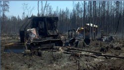 Two Florida firefighters were killed trying to retrieve a stuck tractor when the Blue Ribbon Fire, in Hamilton County, overran them.