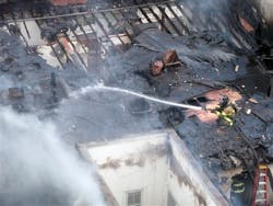 Madison Fire Department personnel work to extinguish a fire which caused extensive damage to the Capitol Hills Apartments on June 30.