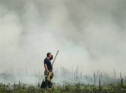 An Athens firefighter wipes his brow as he takes a break from battling a field fire near Tanner High School in Limestone County. An Athens firefighter wipes his brow as he takes a break from battling a field fire near Tanner High School in Limestone County.