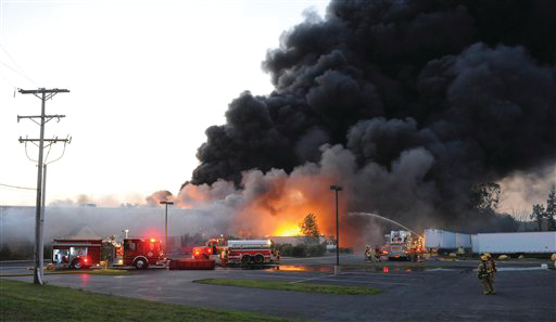 Firefighters work to get water on an industrial fire at Nicos Polymers Group recycling plant in Plainfield Township, Pa.