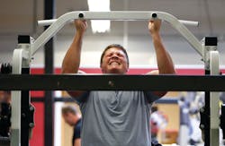 Philadelphia Eagles top draft pick Danny Watkins does pull-ups as he works-out with other Eagles players.