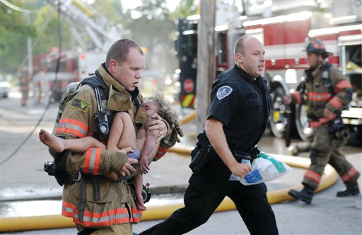 Evansville firefighter Chris Wagener and a police officer rush Aallyah Frazier to an ambulance.