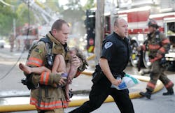 Evansville firefighter Chris Wagener and a police officer rush Aallyah Frazier to an ambulance. Evansville firefighter Chris Wagener and a police officer rush Aallyah Frazier to an ambulance.