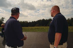Listie Fire Chief Scott Yachere, left, and Assistant Chief Justin Yachere look at a boulder that marks the final resting place of Flight 93.