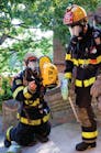 Two Worcester, MA, firefighters suit up prior to testing of a locator/tracking device at Worcester Polytechnic Institute.