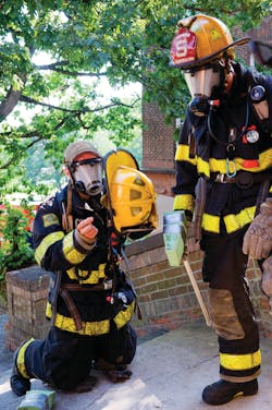 Two Worcester, MA, firefighters suit up prior to testing of a locator/tracking device at Worcester Polytechnic Institute. Two Worcester, MA, firefighters suit up prior to testing of a locator/tracking device at Worcester Polytechnic Institute.
