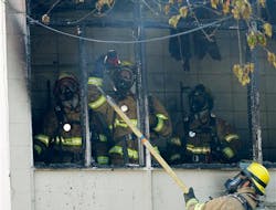 Tacoma firefighters look for hot spots following a fire in a kitchen area of a secondary wing of Lowell Elementary School. Tacoma firefighters look for hot spots following a fire in a kitchen area of a secondary wing of Lowell Elementary School.