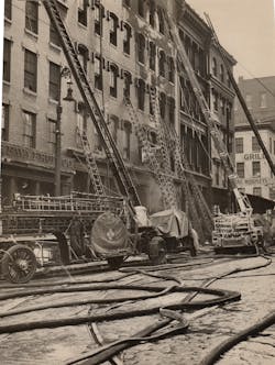 Numerous ground and apparatus-mounted ladders are in position at a building at Pratt and Charles streets in downtown Baltimore, MD, on Jan. 20, 1939.