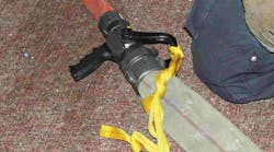 Photo 1. To prevent the accidental shutting down of water to the nozzle team, take the webbing and tie the nozzle bale in the open position.