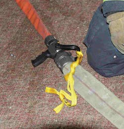 Photo 1. To prevent the accidental shutting down of water to the nozzle team, take the webbing and tie the nozzle bale in the open position. Photo 1. To prevent the accidental shutting down of water to the nozzle team, take the webbing and tie the nozzle bale in the open position.