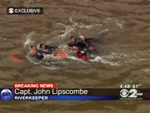 In this frame grab image taken from WCBS-TV, survivors are pulled ashore by rescue workers following a crash in the East River in New York.