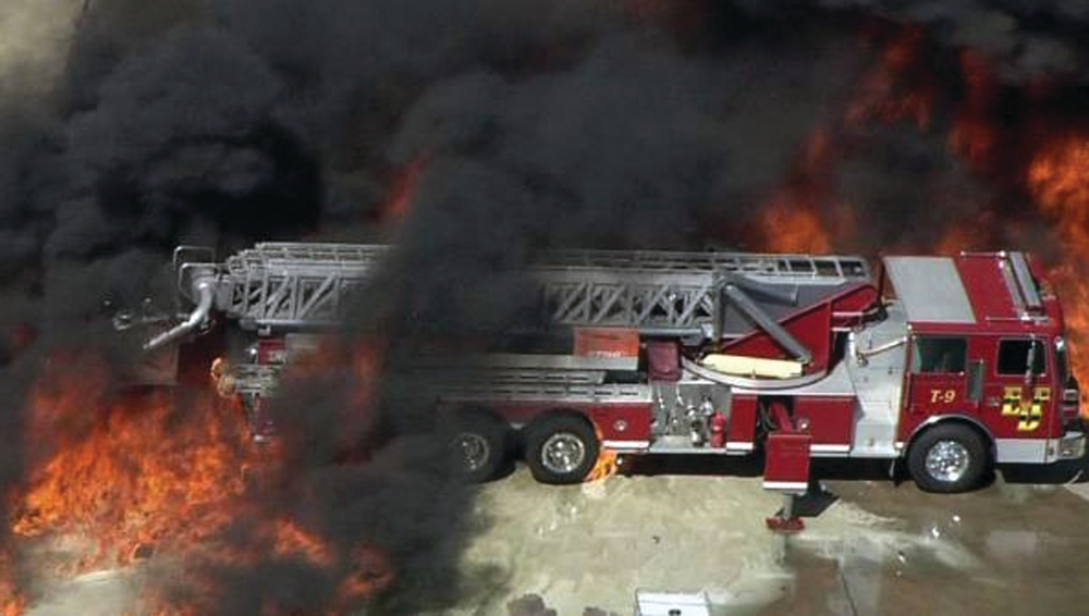 A frame grab provided by WFAA.com shows flames approaching a fire truck at the Magnablend Chemical Plant in Waxahachie, Texas.