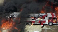 A frame grab provided by WFAA.com shows flames approaching a fire truck at the Magnablend Chemical Plant in Waxahachie, Texas.