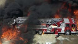 A frame grab provided by WFAA.com shows flames approaching a fire truck at the Magnablend Chemical Plant in Waxahachie, Texas.