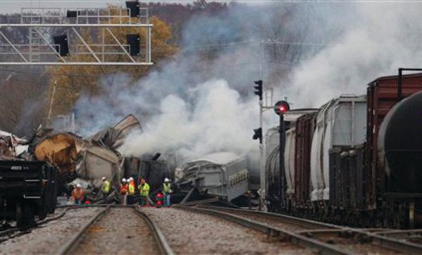 Officials survey damage at the sight of a freight train derailment in Bartlett, Ill.