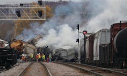 Officials survey damage at the sight of a freight train derailment in Bartlett, Ill.