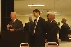 Former Deputy USFA Administrator Charlie Dickinson, left, presents challenge coins to Hal Bruno's sons, Harold, left, and Danny.