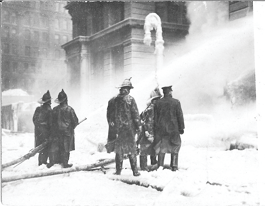 NEW YORK CITY, JAN. 9, 1912 &ndash; Firefighters operate hoselines from the dangerously icy street outside the burning Equitable Life Assurance Building at 120 Broadway in Manhattan. See page XX for a detailed account of the fire.