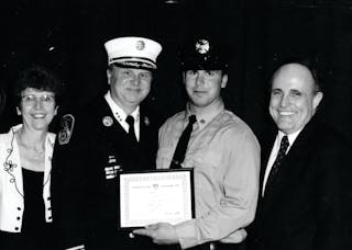 Chief Donald J. Burns (second from left) at his son Patrick&rsquo;s induction ceremony, with his wife, Elizabeth, and former New York City Mayor Rudy Giuliani.