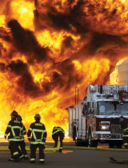 Fairfield, CA, Truck 35 repositions due to radiant heat and advancing flames during a seven-alarm fire at a plastics-manufacturing plant. Twelve departments responded to the fire on July 26, 2011. See cover story on page 48.