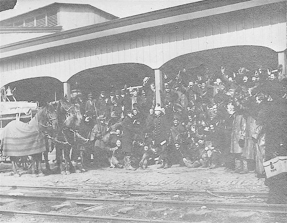 IT HAPPENED IN FEBRUARY. Baltimore City, MD, Fire Chief August Emrich, his eyes bandaged due to smoke injuries, shakes hands with FDNY Battalion Chief John Howe as New York City firemen prepare to return home after helping battle the Great Baltimore Fire in February 1904.