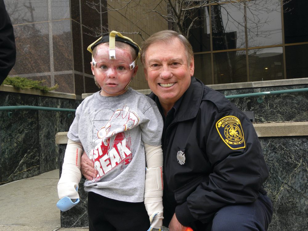 Landon Cooper, a patient at Shriners Hospitals for Children in Cincinnati, OH, and retired Fire Specialist Bobby Smith of the Cincinnati Fire Department.